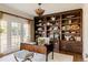 Traditional office with built-in shelves, a desk, and french doors letting in natural light at 5700 S Steele St, Greenwood Village, CO 80121