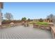 Spacious deck with stone accents and wood floor overlooking the landscaped backyard with play structure at 5130 S Wenatchee St, Aurora, CO 80015