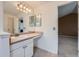 Bright bathroom featuring a large mirror, vanity with storage, and neutral finishes at 5130 S Wenatchee St, Aurora, CO 80015
