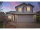Charming two-story home with a two-car garage, red shutters, and low maintenance rock landscaping at 5130 S Wenatchee St, Aurora, CO 80015