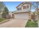 Well-maintained two-story home with a two-car garage, mature landscaping, and a spacious driveway at 5130 S Wenatchee St, Aurora, CO 80015