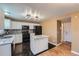 Updated kitchen features an island, black appliances, granite countertops, and black tile floors at 5130 S Wenatchee St, Aurora, CO 80015