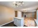 View from kitchen shows kitchen island and eat-in space with fireplace at 5130 S Wenatchee St, Aurora, CO 80015