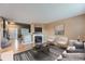 Comfortable living room featuring a fireplace, hardwood floors, neutral paint, and bright window at 5130 S Wenatchee St, Aurora, CO 80015