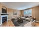 Cozy living room with a fireplace, neutral paint, hardwood floors, and bright window at 5130 S Wenatchee St, Aurora, CO 80015