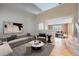 Open-concept living room featuring a soaring ceiling, hardwood floors, and comfortable seating at 5130 S Wenatchee St, Aurora, CO 80015