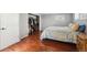 Cozy bedroom with hardwood floors, ample closet space, and a comfortable bed setting at 6690 Albion St, Commerce City, CO 80022