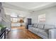 Spacious living area showcasing hardwood floors, an open layout, and seamless transition to the kitchen at 6690 Albion St, Commerce City, CO 80022