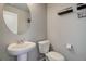 Small bathroom with pedestal sink and toilet at 28418 E 8Th Pl, Watkins, CO 80137