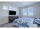 Main bedroom with large windows, dresser, and blue bedding at 28418 E 8Th Pl, Watkins, CO 80137