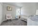 Bedroom with a crib, changing table, and a rocking chair at 28418 E 8Th Pl, Watkins, CO 80137