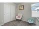 Bedroom with rocking chair, crib, and plenty of closet space at 28418 E 8Th Pl, Watkins, CO 80137