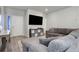 Living room with sectional sofa and built-in storage at 28418 E 8Th Pl, Watkins, CO 80137