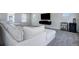 Spacious living room with sectional sofa and bar area at 28418 E 8Th Pl, Watkins, CO 80137
