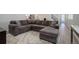 Open living area with L-shaped sectional sofa and wood floors at 28418 E 8Th Pl, Watkins, CO 80137