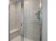 Clean shower with gray tile and a built-in seat at 28418 E 8Th Pl, Watkins, CO 80137