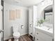 Nicely decorated bathroom with a modern vanity, round mirror, and wood-look flooring at 1080 S Yampa St, Aurora, CO 80017