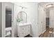 Stylish bathroom with a modern vanity, round mirror, and updated fixtures at 1080 S Yampa St, Aurora, CO 80017