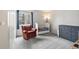 Bright bedroom featuring neutral carpet, natural light, and relaxing rocking chair at 1080 S Yampa St, Aurora, CO 80017