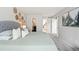 Primary bedroom with closet and partial bath access featuring neutral decor and woven wall art at 1080 S Yampa St, Aurora, CO 80017