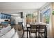 Bright dining area features a modern table set, skylight views to kitchen, and access to outdoors at 1080 S Yampa St, Aurora, CO 80017