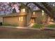 Two-story tan home with black framed windows, front door, and a walkway at 1080 S Yampa St, Aurora, CO 80017