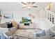 Inviting living room with a comfortable sofa, modern entertainment center, and ceiling fan at 1080 S Yampa St, Aurora, CO 80017