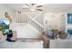 Comfortable living room featuring a fan, gray walls, a staircase, and an inviting entrance at 1080 S Yampa St, Aurora, CO 80017