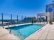 Luxury rooftop pool with city views; features lounge chairs and glass railings at 891 14Th St # 3704, Denver, CO 80202