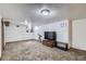 Finished basement with neutral carpet, white walls, and a window allowing natural light at 1328 S Zuni St, Denver, CO 80223