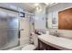 Bathroom with a vanity, mirrored medicine cabinet, and a shower behind frosted glass at 1328 S Zuni St, Denver, CO 80223
