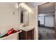 Bathroom featuring a tiled wall, a dark cabinet, and a light fixture with 6 bulbs at 1328 S Zuni St, Denver, CO 80223