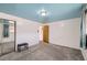 Bright bedroom featuring carpeted floors, a mirrored closet, and a light blue ceiling at 1328 S Zuni St, Denver, CO 80223