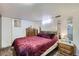 Bedroom with mirrored closet and a burgundy plush bed at 1328 S Zuni St, Denver, CO 80223