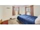 Cozy bedroom with two windows with mini blinds and a comfy blue bed at 1328 S Zuni St, Denver, CO 80223