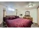 Bedroom with mirrored closet and a burgundy plush bed at 1328 S Zuni St, Denver, CO 80223
