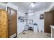 Functional laundry room with washer, dryer, sink, and ample storage space at 1328 S Zuni St, Denver, CO 80223