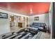 Cozy living room featuring a modern rug, gray sofa, and a unique red ceiling with stylish lighting at 1328 S Zuni St, Denver, CO 80223