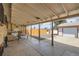 Covered patio with picnic table and access to the fenced backyard and detached garage at 1328 S Zuni St, Denver, CO 80223