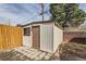 Backyard shed with a door and window, enclosed by a wooden fence at 1328 S Zuni St, Denver, CO 80223