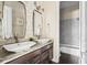 Bright bathroom with dual sinks, granite countertops, and decorative mirrors at 14303 Glenayre Cir, Parker, CO 80134