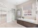 Bright bathroom features a soaking tub, a tiled glass shower and a door to a walk-in closet at 14303 Glenayre Cir, Parker, CO 80134