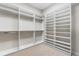 Large walk-in closet with carpeted floors and custom shelving at 14303 Glenayre Cir, Parker, CO 80134