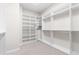 Bright walk-in closet with carpeted floors, custom shelving and clothing racks at 14303 Glenayre Cir, Parker, CO 80134