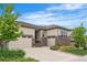 Stunning home with a three-car garage, stone accents, beautiful landscaping, and well-maintained front yard at 14303 Glenayre Cir, Parker, CO 80134