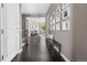 Spacious foyer with dark wood floors, a bench and art leading into a living room at 14303 Glenayre Cir, Parker, CO 80134