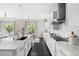 Bright kitchen with dark wood flooring and a view into the breakfast nook at 14303 Glenayre Cir, Parker, CO 80134