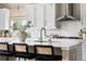 A kitchen island offers lots of light and is adorned with elegant black and cane barstools at 14303 Glenayre Cir, Parker, CO 80134