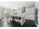 Modern kitchen with a central island, stainless steel appliances, and a dining area with a chandelier at 14303 Glenayre Cir, Parker, CO 80134