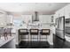 Modern kitchen with a central island, stainless steel appliances, and counter seating at 14303 Glenayre Cir, Parker, CO 80134
